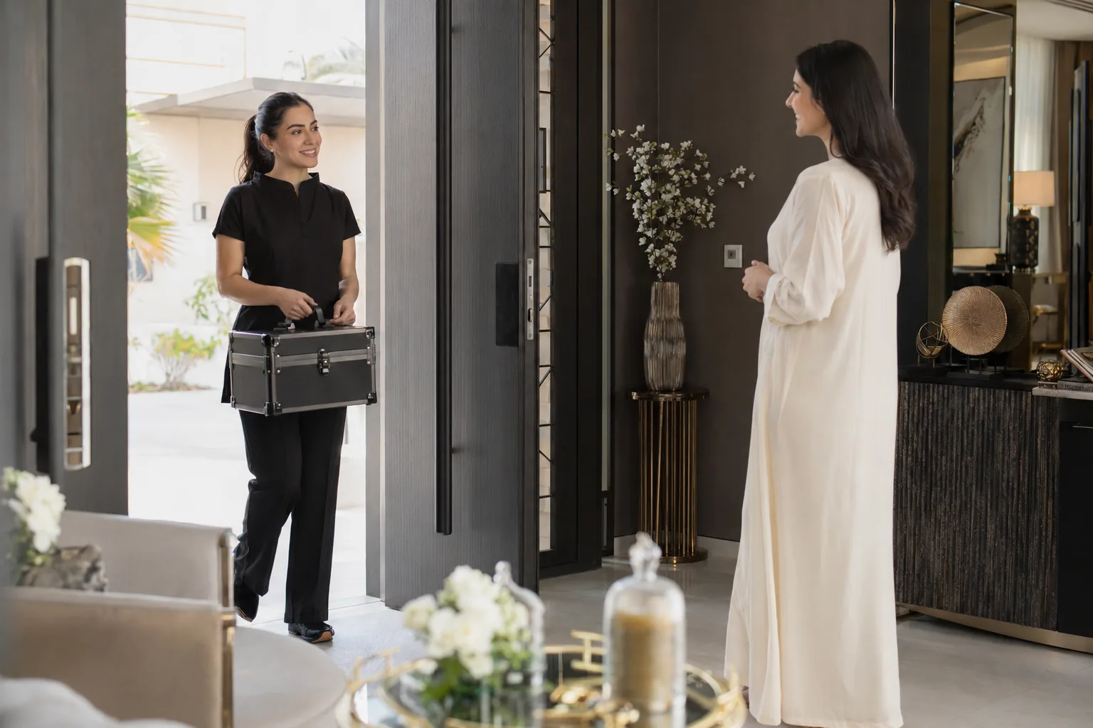 Female beauty therapist arriving with an unbranded kit for a UAE home salon appointment